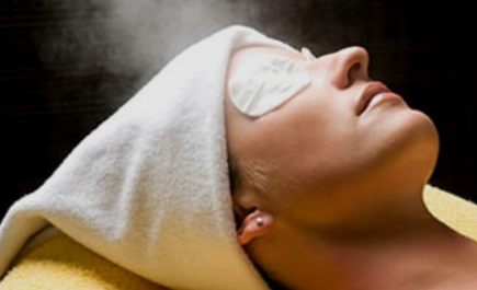 Woman relaxing during a facial treatment